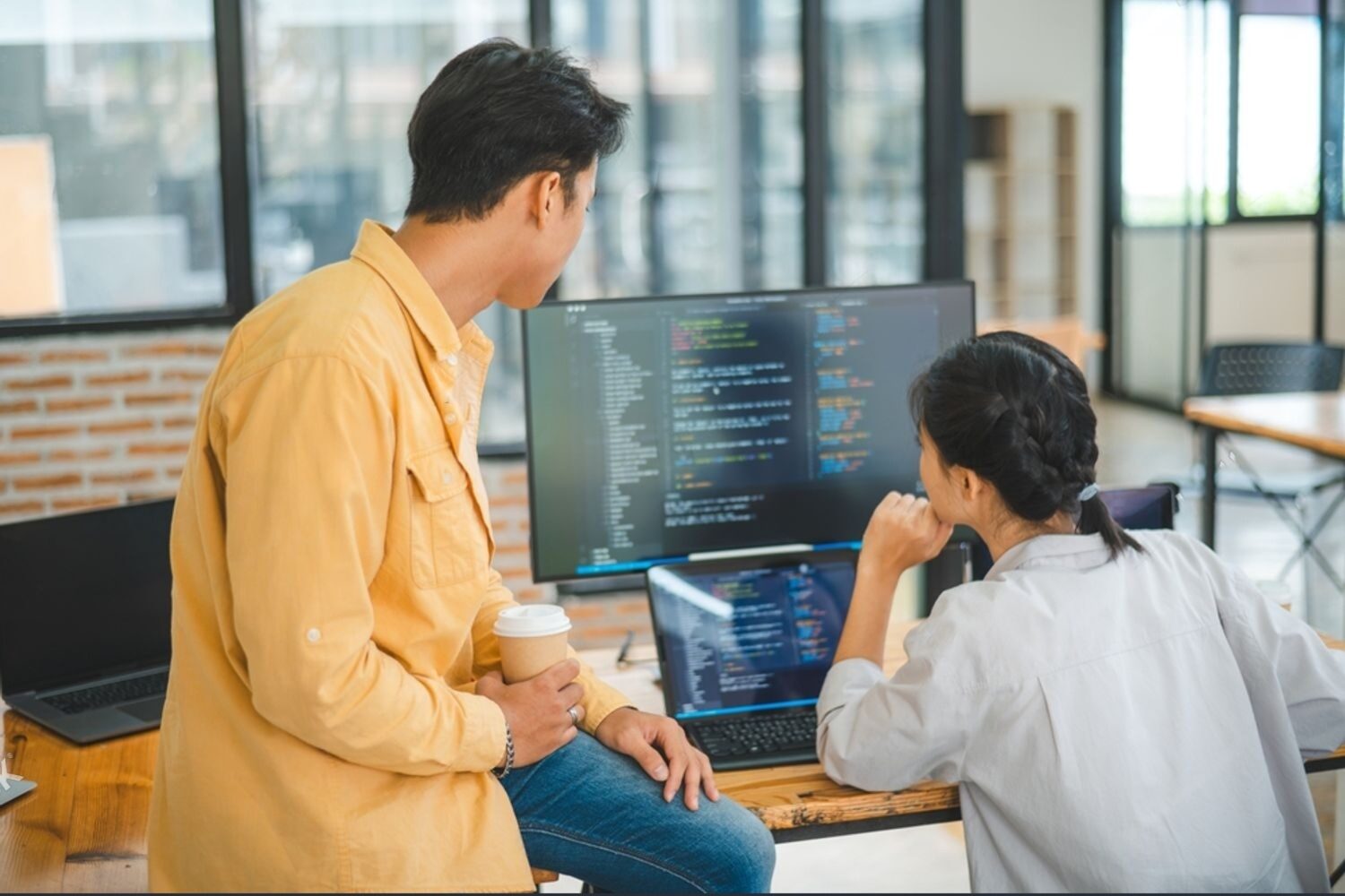 A software engineer closely reviewing code during a focused work session.
